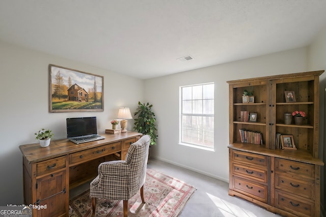 home office with visible vents, baseboards, and light colored carpet