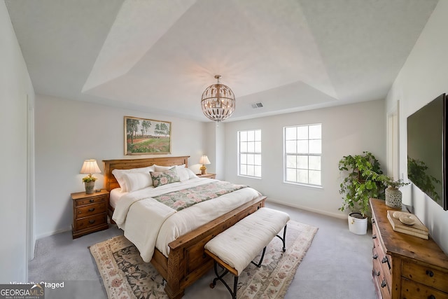 bedroom featuring a raised ceiling, baseboards, visible vents, and light carpet