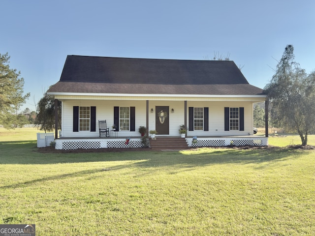 view of front of home with covered porch, a front lawn, and roof with shingles