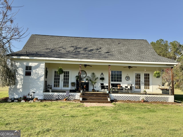 rear view of house with a ceiling fan, a yard, and french doors