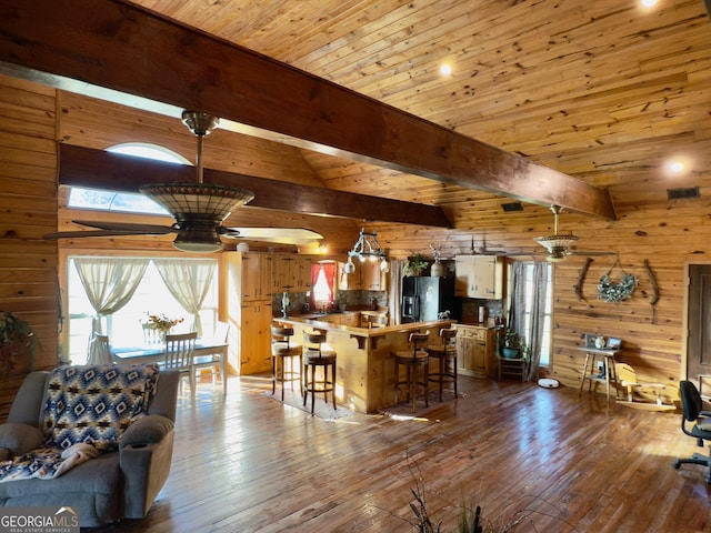 living room with wood ceiling, wooden walls, a ceiling fan, and wood-type flooring