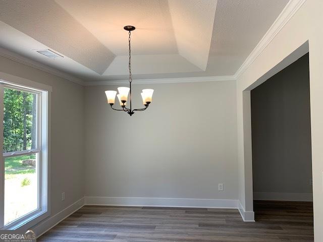 unfurnished room featuring a wealth of natural light, visible vents, ornamental molding, and a chandelier