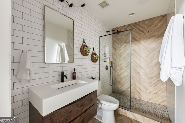 bathroom with visible vents, backsplash, a walk in shower, vanity, and tile walls