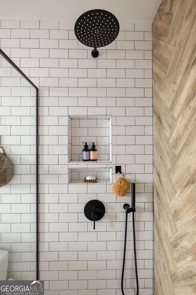 interior space with tiled shower