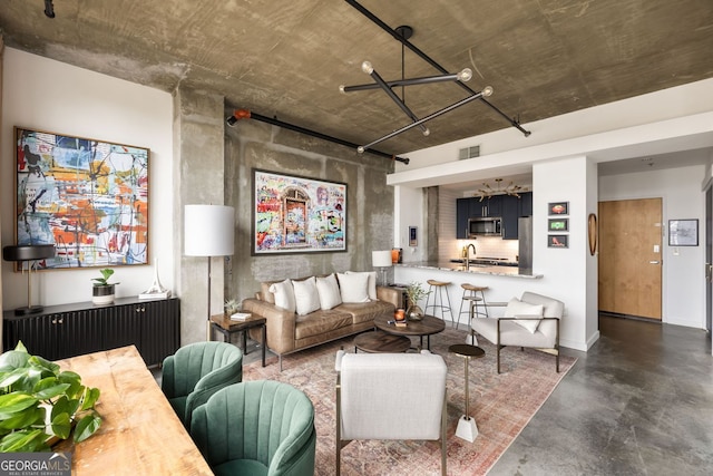 living room with visible vents, concrete flooring, and baseboards