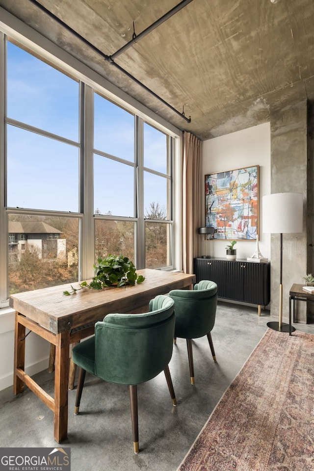 dining space with finished concrete floors and radiator