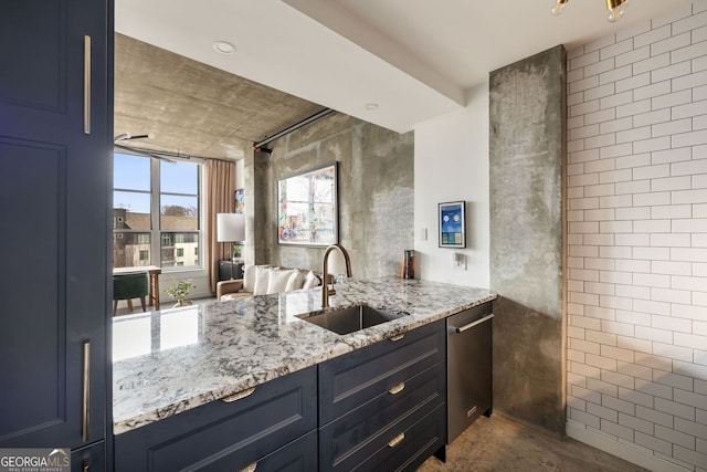 kitchen with dishwasher, light stone counters, blue cabinets, and a sink