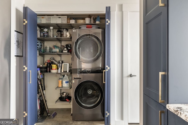 washroom featuring stacked washer and dryer and laundry area