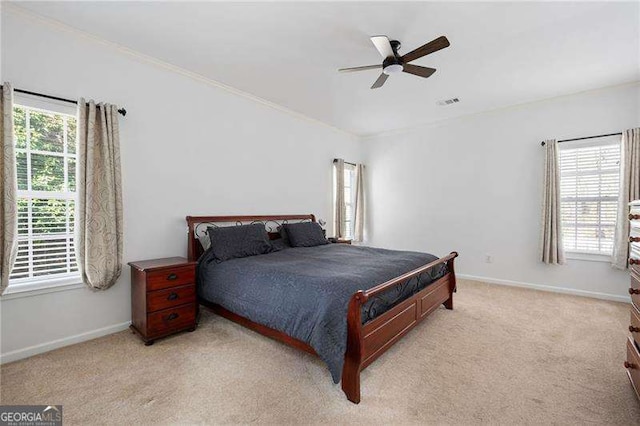 bedroom with baseboards, light carpet, visible vents, and a ceiling fan