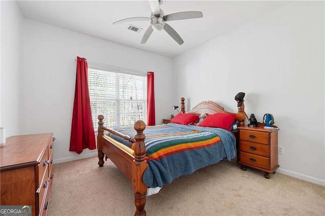 bedroom featuring light carpet, visible vents, ceiling fan, and baseboards