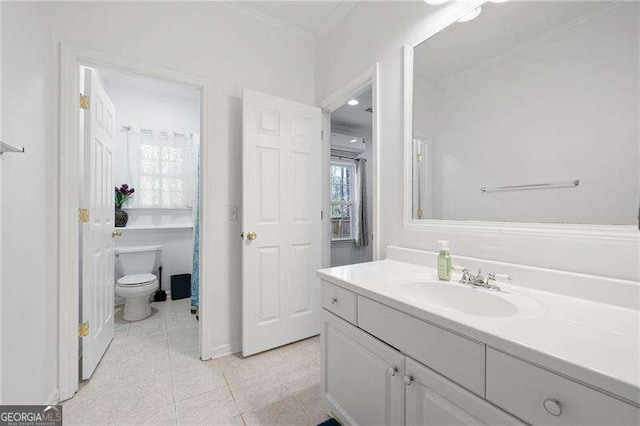 bathroom with toilet, ornamental molding, tile patterned flooring, baseboards, and vanity