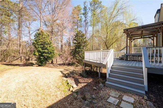 view of yard with a wooden deck and fence