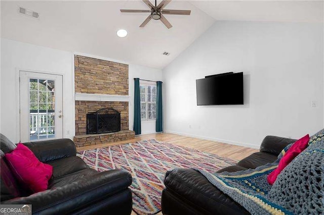 living room with wood finished floors, a ceiling fan, visible vents, and baseboards