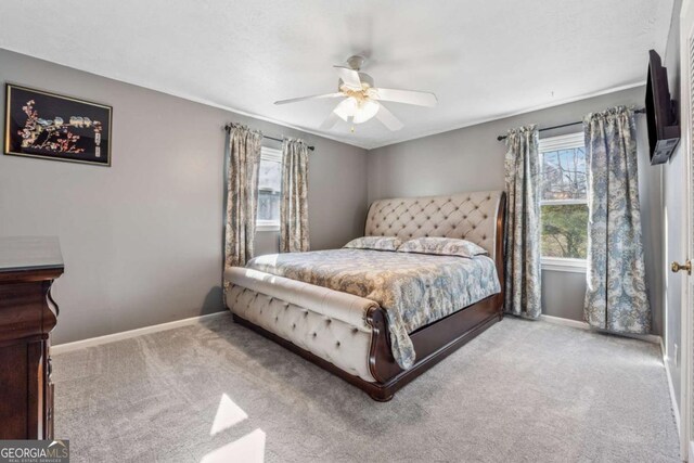 carpeted bedroom with baseboards and ceiling fan