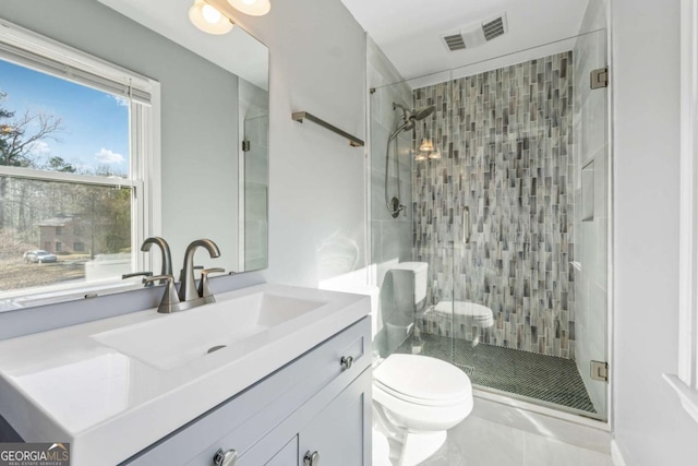 full bathroom with vanity, toilet, visible vents, and a stall shower