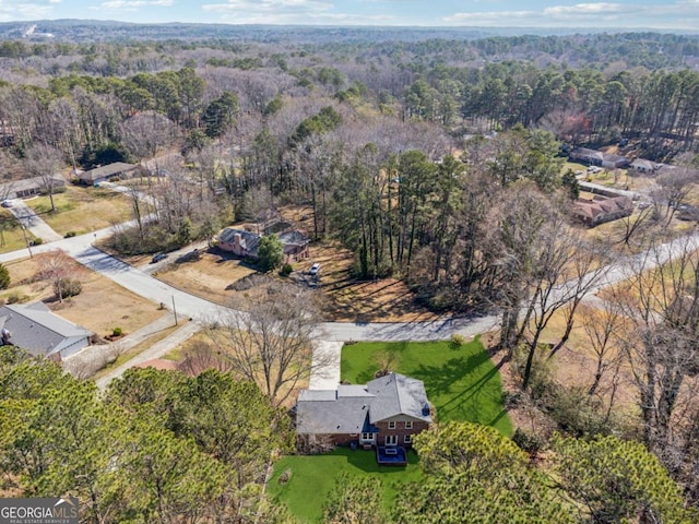 bird's eye view featuring a wooded view