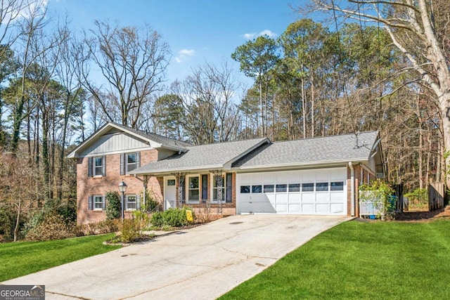 split level home featuring driveway, board and batten siding, a front yard, a garage, and brick siding