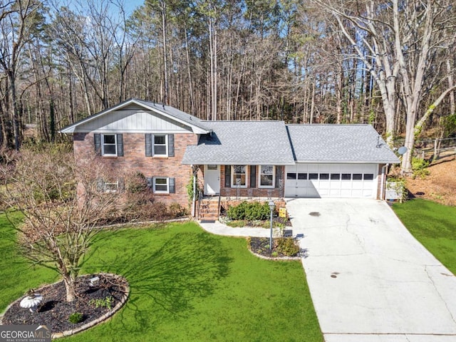 tri-level home featuring a front lawn, concrete driveway, a shingled roof, a garage, and brick siding