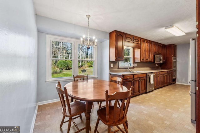 dining room with baseboards, light floors, and a chandelier