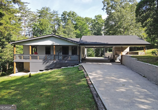 ranch-style house featuring a front lawn, driveway, a porch, a shingled roof, and a carport