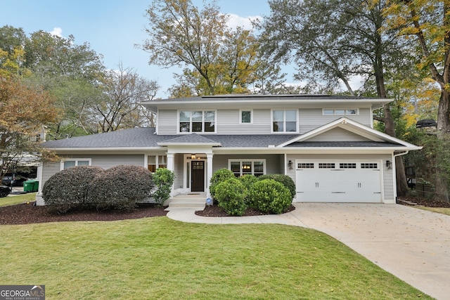 traditional-style house with solar panels, concrete driveway, and a front lawn