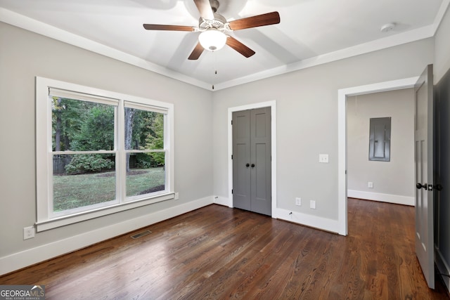 unfurnished bedroom featuring ceiling fan, visible vents, baseboards, and dark wood finished floors