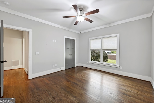 unfurnished bedroom featuring visible vents, ornamental molding, a ceiling fan, dark wood-style floors, and baseboards