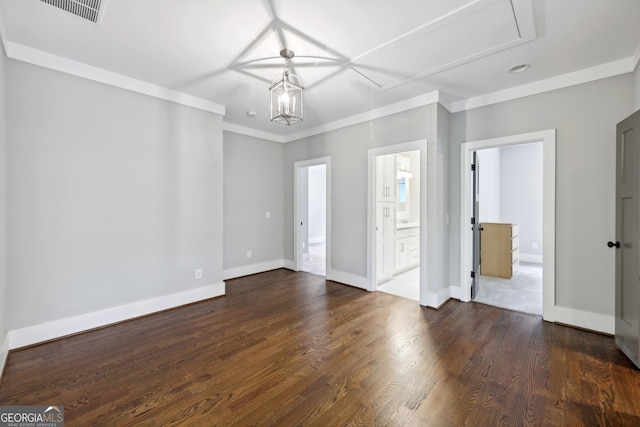 interior space with visible vents, dark wood-type flooring, baseboards, attic access, and ornamental molding