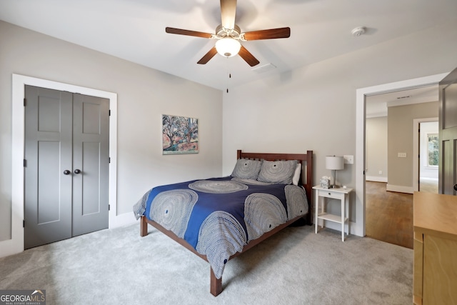 carpeted bedroom with baseboards and ceiling fan