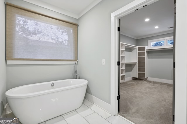 full bath with visible vents, recessed lighting, baseboards, a freestanding bath, and a spacious closet