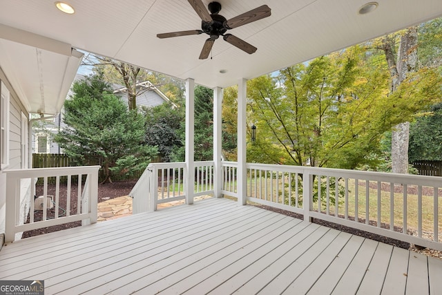 deck with ceiling fan and fence