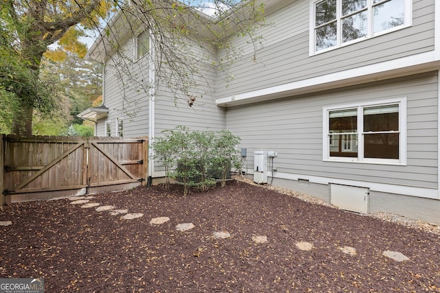 view of yard featuring fence and a gate