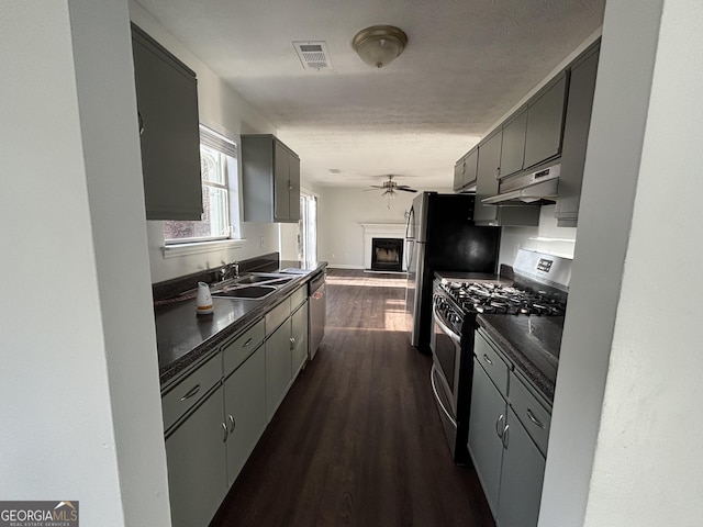 3789 Conley Downs Ln, Decatur, GA 30034 - kitchen with dark countertops, appliances with stainless steel finishes, under cabinet range hood, and a sink
