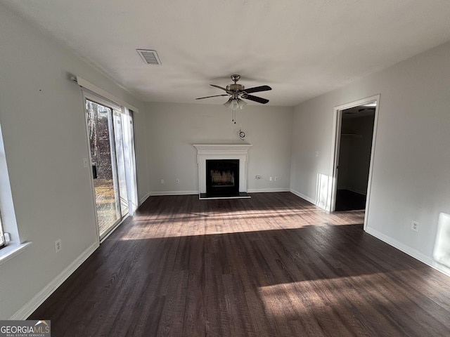 3789 Conley Downs Ln, Decatur, GA 30034 - unfurnished living room featuring visible vents, a fireplace with raised hearth, ceiling fan, baseboards, and dark wood-style flooring