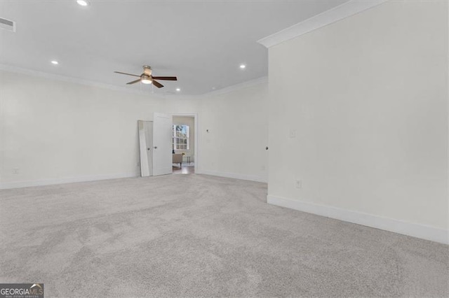 empty room with ornamental molding, recessed lighting, baseboards, light colored carpet, and ceiling fan