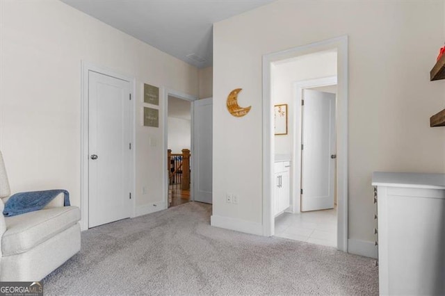 sitting room featuring carpet and baseboards