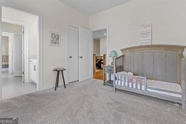 tiled bedroom with carpet flooring and baseboards