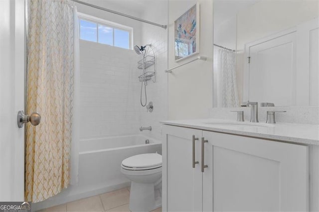 bathroom featuring tile patterned flooring, toilet, vanity, and shower / bath combo