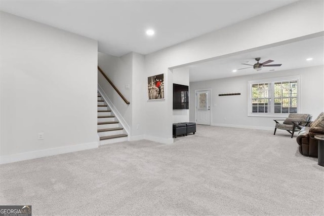 living room with light carpet, recessed lighting, and baseboards