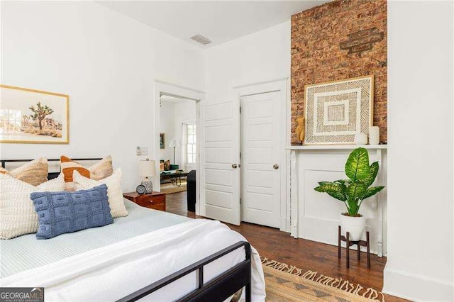 bedroom featuring wood finished floors and visible vents