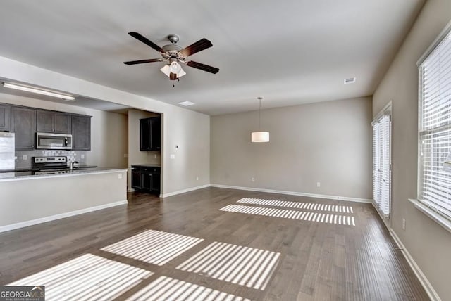 3082 Cedar Glade Ln NE, Buford, GA 30519 - unfurnished living room with dark wood-type flooring, a ceiling fan, and baseboards