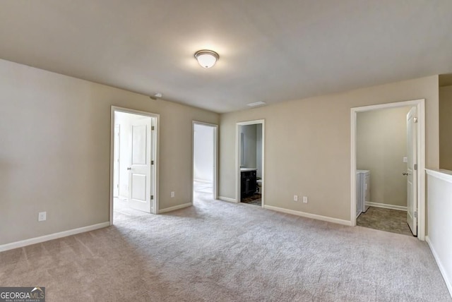 unfurnished bedroom featuring baseboards, carpet, and ensuite bathroom