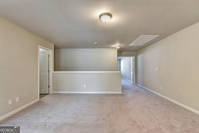 empty room featuring baseboards and carpet