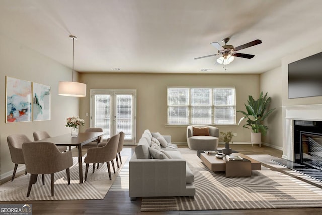 3082 Cedar Glade Ln NE, Buford, GA 30519 - living area featuring ceiling fan, baseboards, wood finished floors, and a fireplace with flush hearth