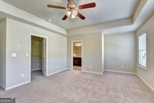 3082 Cedar Glade Ln NE, Buford, GA 30519 - unfurnished bedroom featuring a walk in closet, light colored carpet, and baseboards
