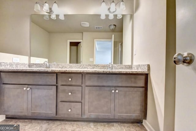 full bath with double vanity, visible vents, and a sink