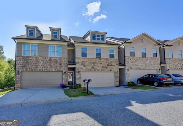 view of front of house featuring concrete driveway, a garage, and stone siding