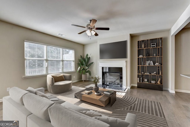 3082 Cedar Glade Ln NE, Buford, GA 30519 - living area featuring a fireplace, wood finished floors, ceiling fan, and baseboards