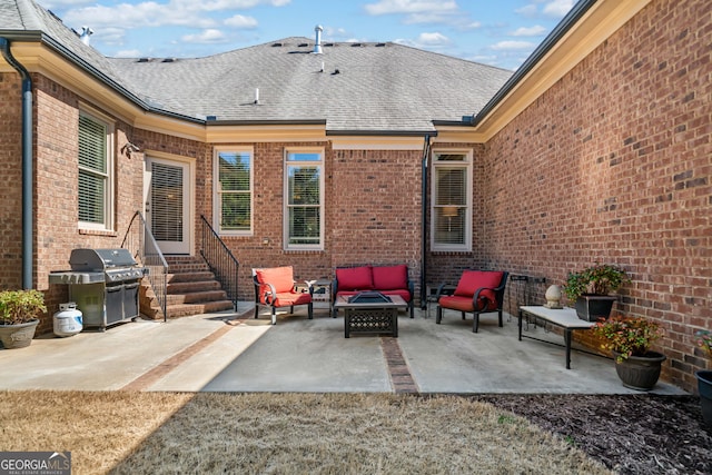 view of patio / terrace featuring area for grilling, entry steps, and an outdoor living space with a fire pit