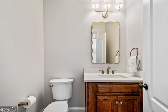 bathroom with toilet and vanity